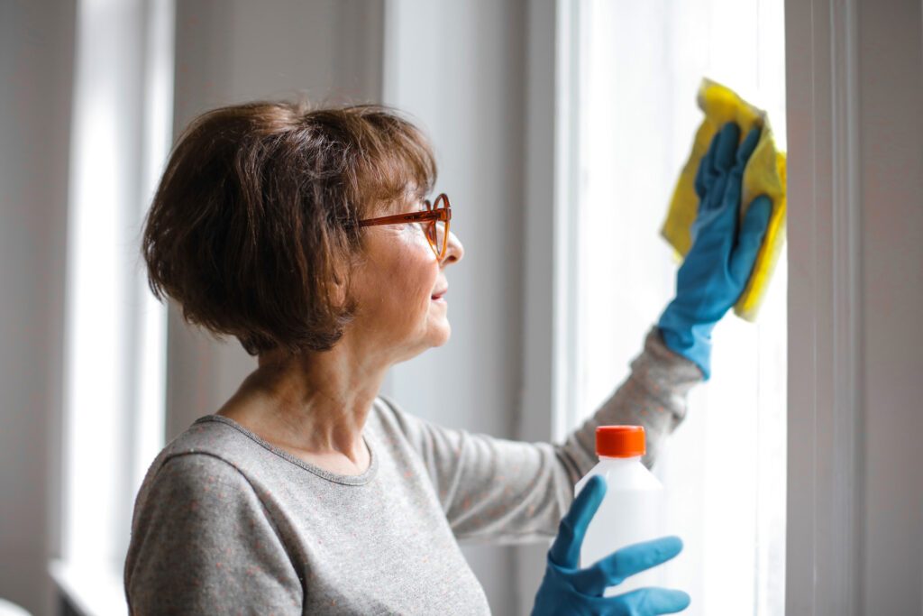 Woman making one of the most common cleaning mistakes homeowners make