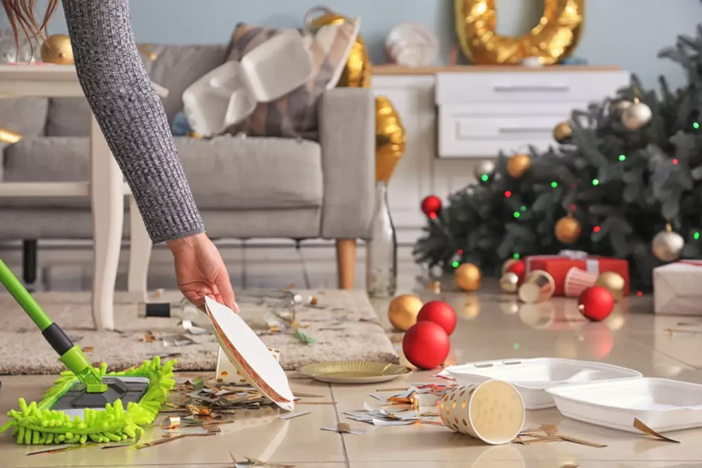 Woman cleaning up room after New Year party