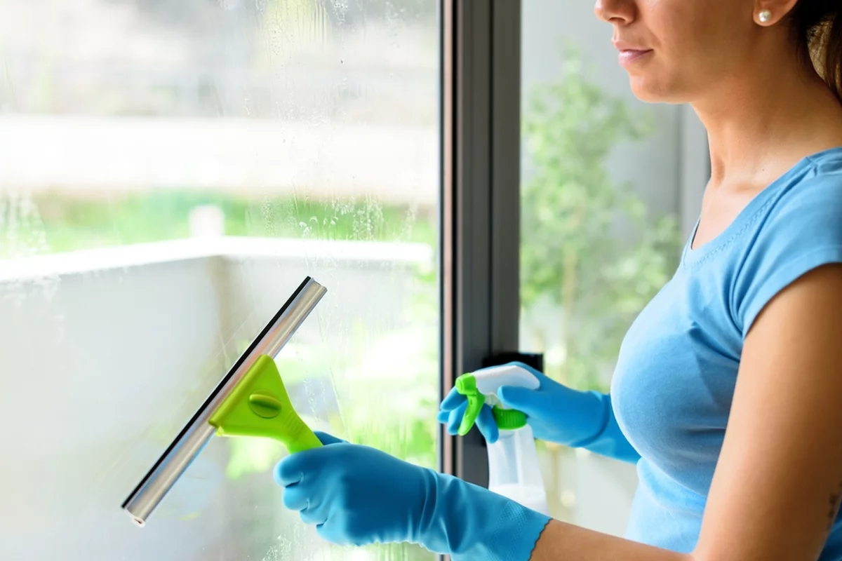 A woman cleaning her windows.
